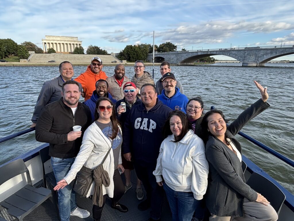 Community IT staff on a boat near the Lincoln Monument in Washington DC.